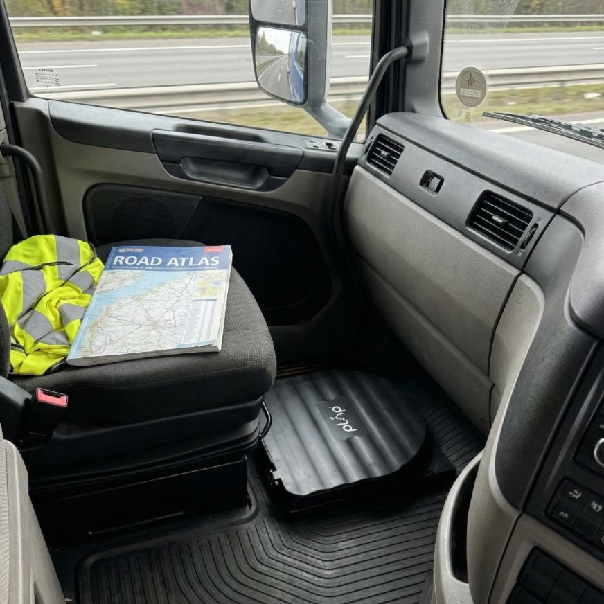 PlopGo toilet kit folded in the passenger footwell of a lorry