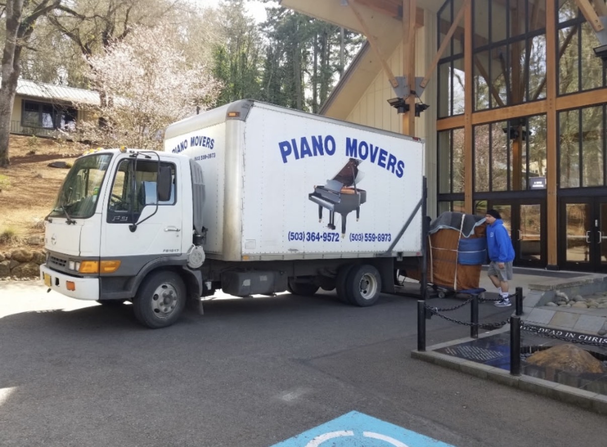 JJ & C Movers crew moving a piano in Salem, Oregon