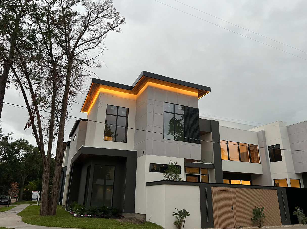 Home exterior at night with AudioVision lighting and AV systems