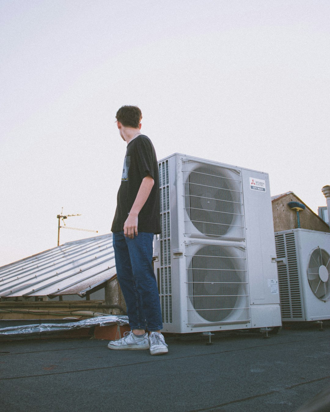 HVAC technician at rooftop AC units