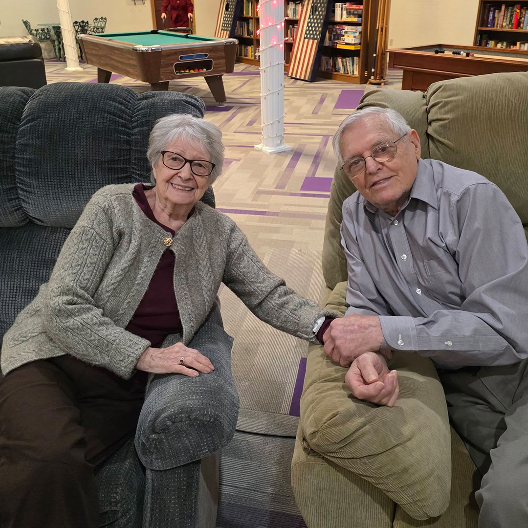 Caregiver providing compassionate assisted living support to a resident at Bay View Gardens