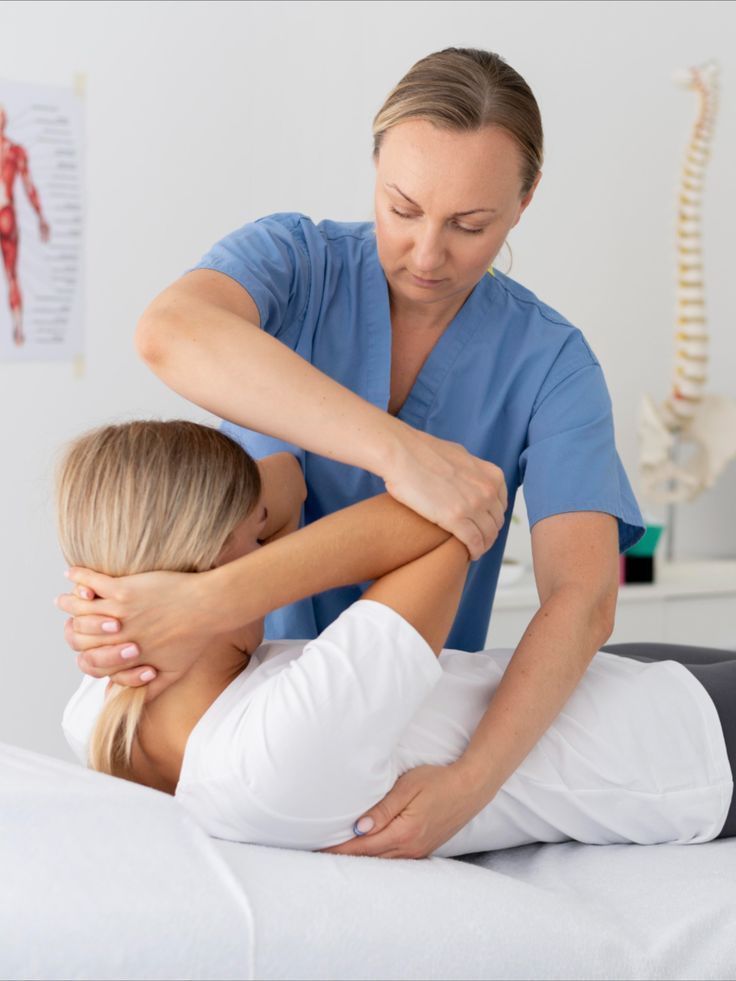 Physiotherapist mobilising a patient's shoulder