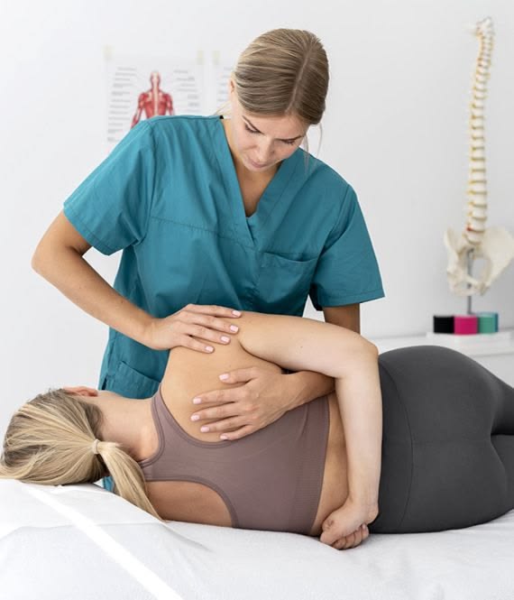 Clinician adjusting a patient's lower back