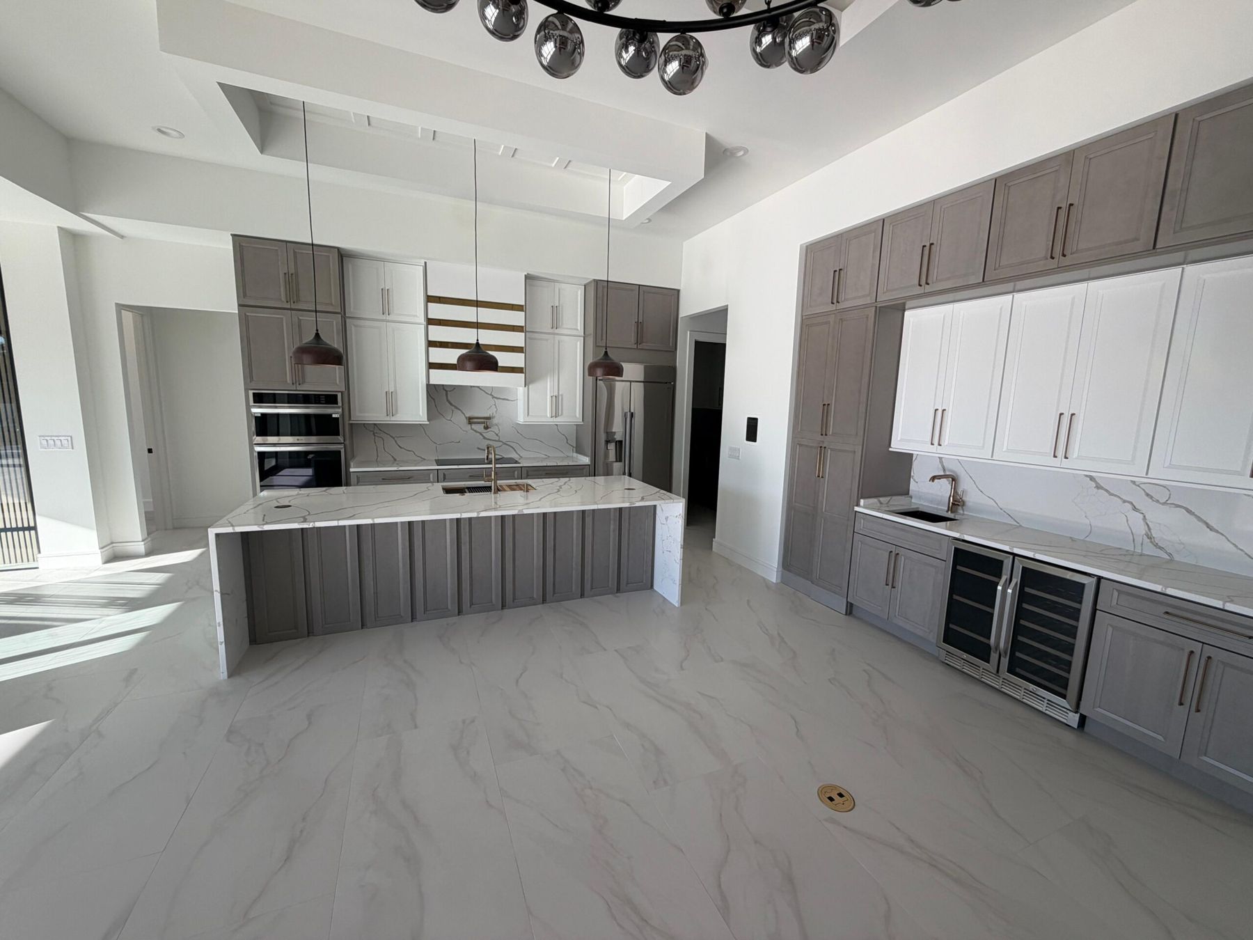 Quartz waterfall island with matching backsplash