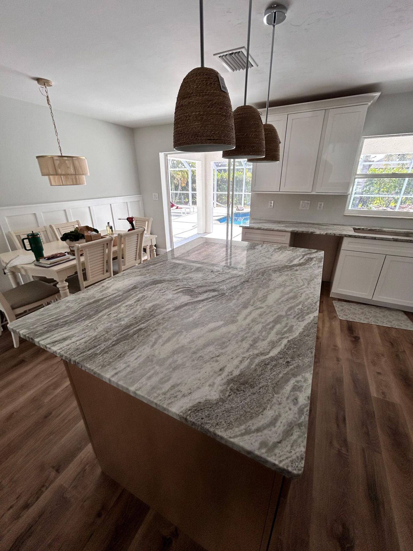 Natural stone island under rattan pendants
