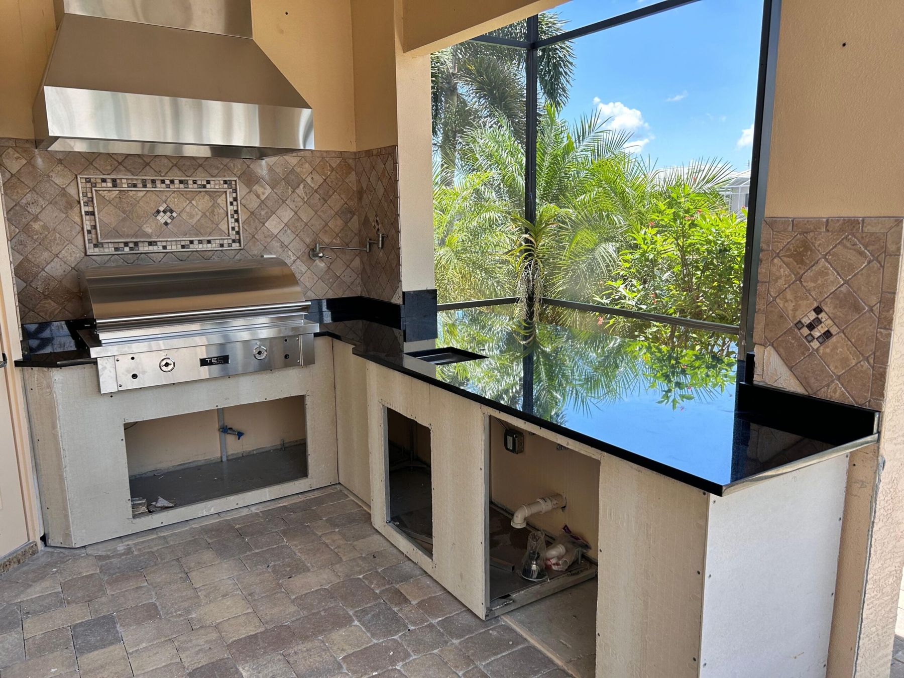 Black granite outdoor kitchen on a lanai
