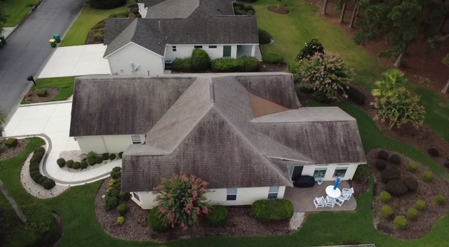 Aging asphalt shingle roof before Roof Juice RX treatment