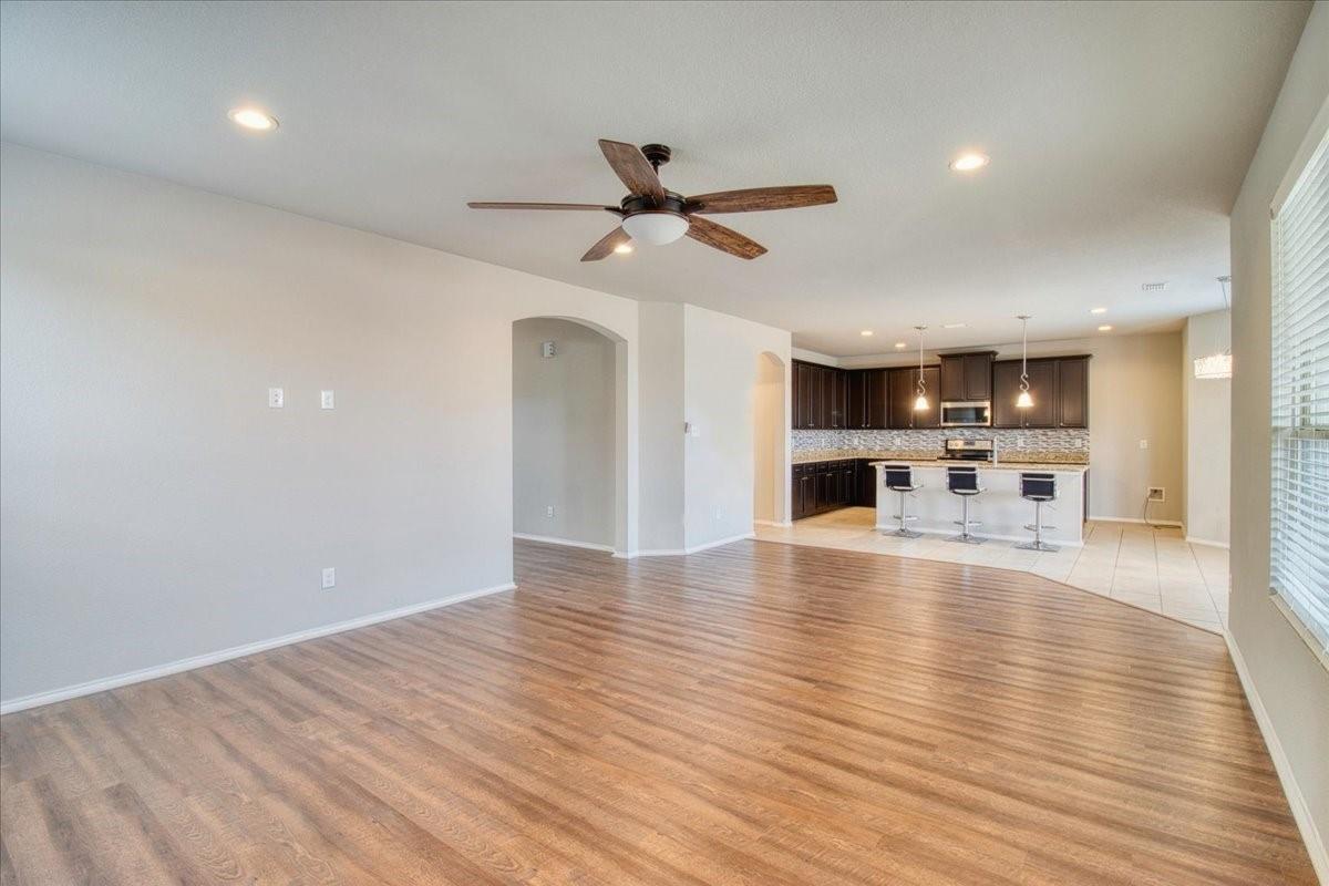 Spacious living area with wood-finish flooring