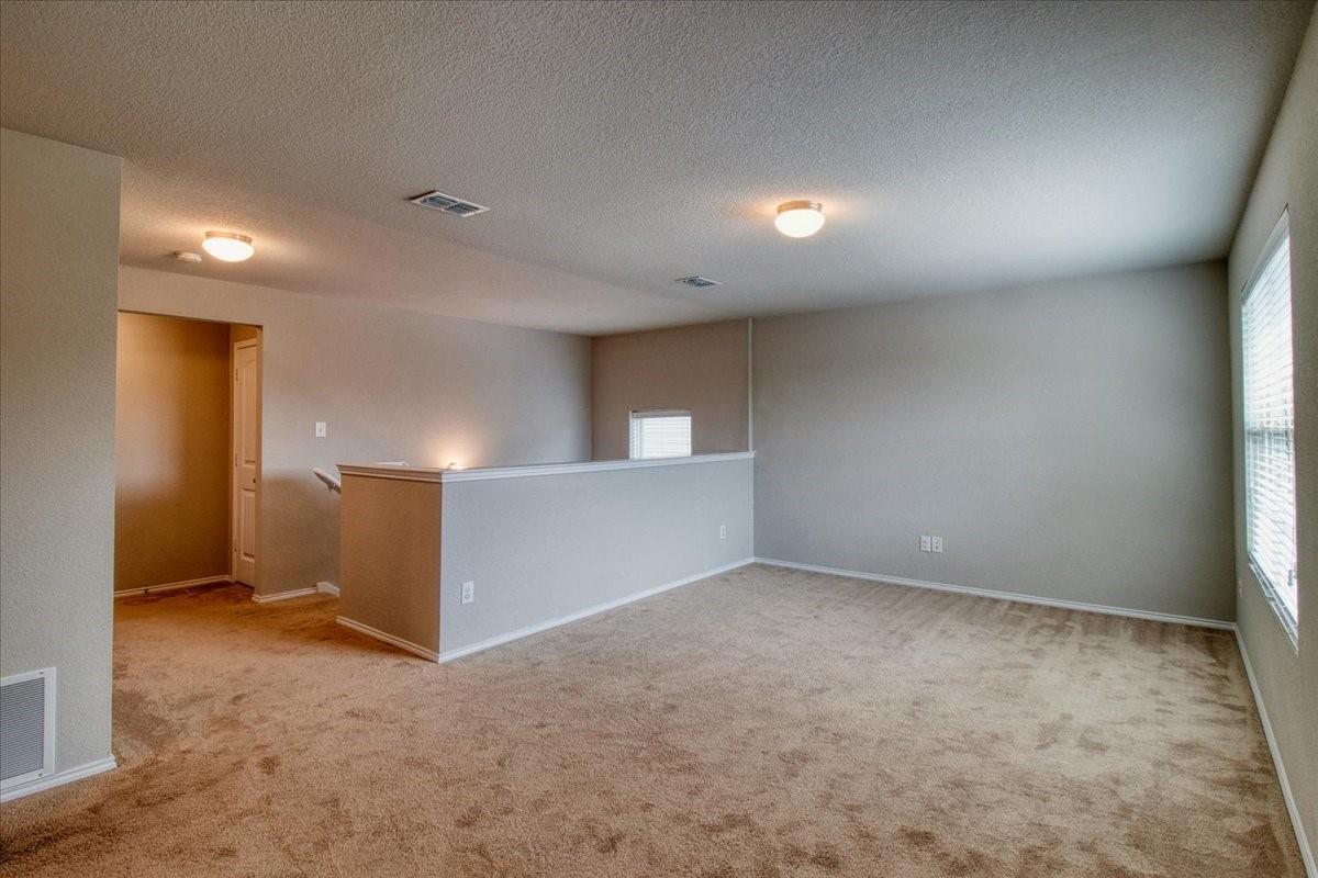 Upstairs game room with neutral tones