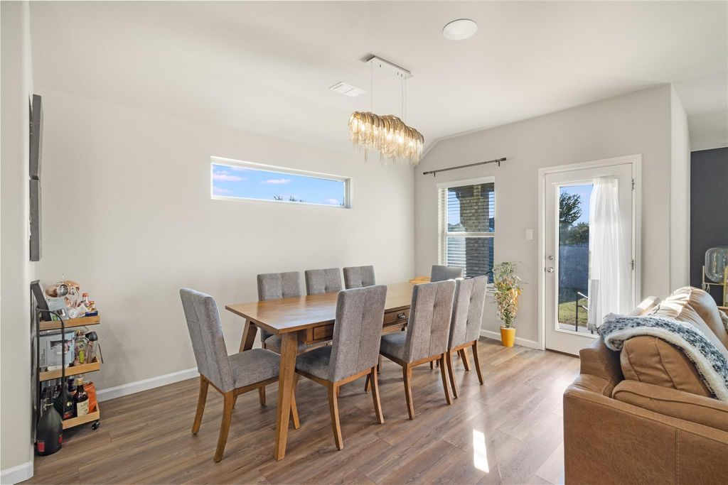 Dining room with 8-seat table and modern chandelier