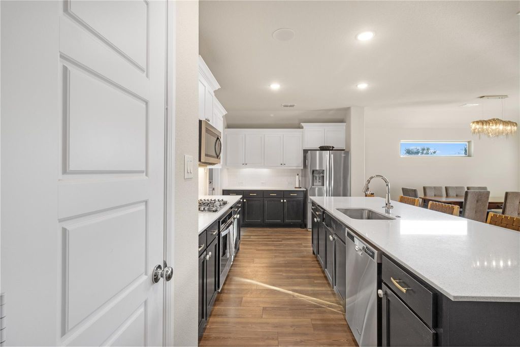 Kitchen from alternate angle showing island and dining area