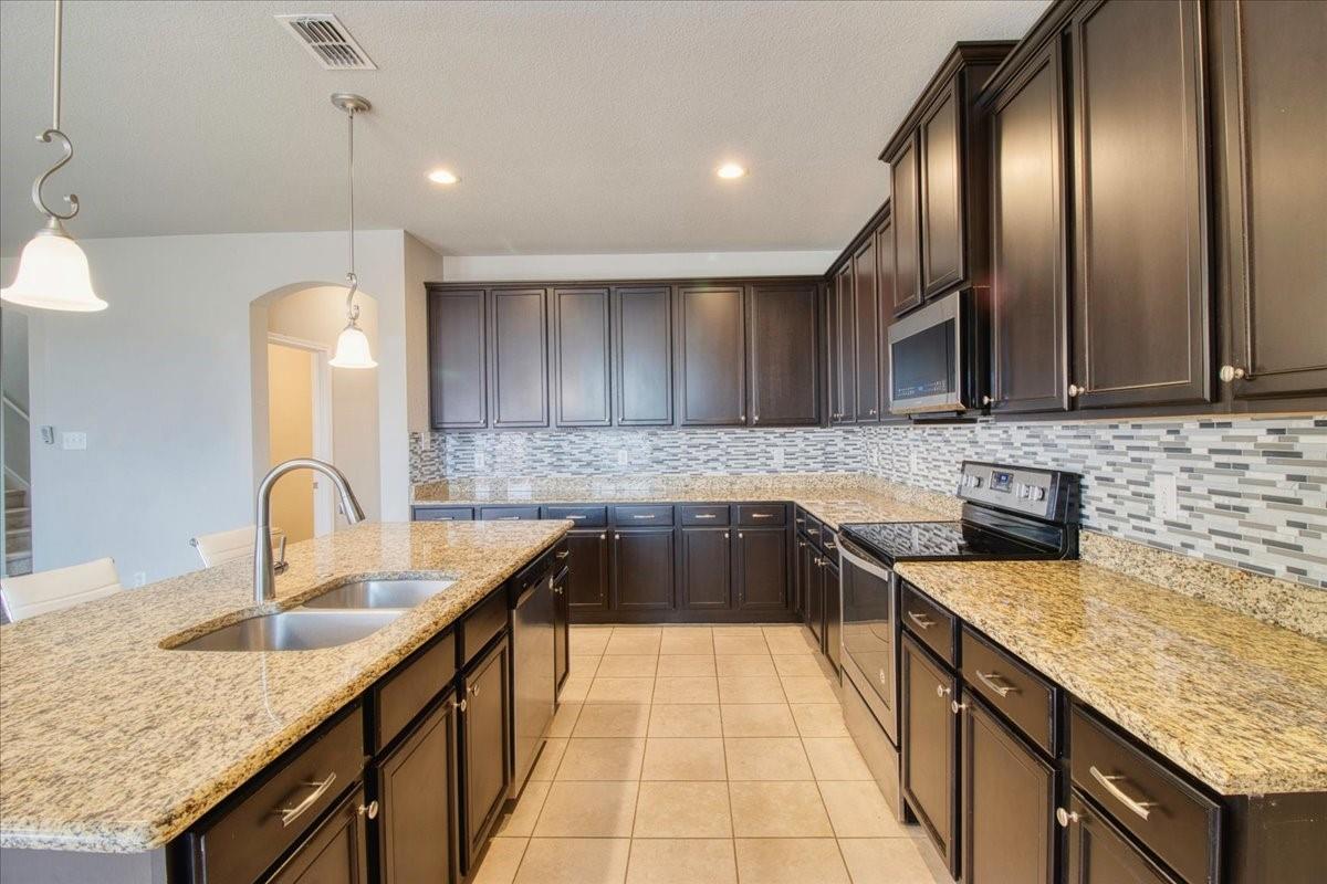 Kitchen with granite counters and island