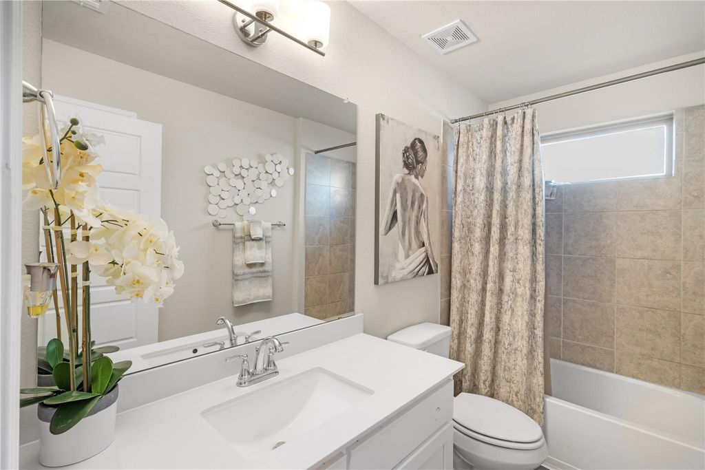 Bathroom with vanity and tub-shower combo