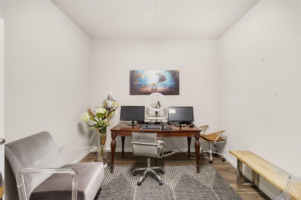 Oversized laundry room doubling as home office with dual monitors