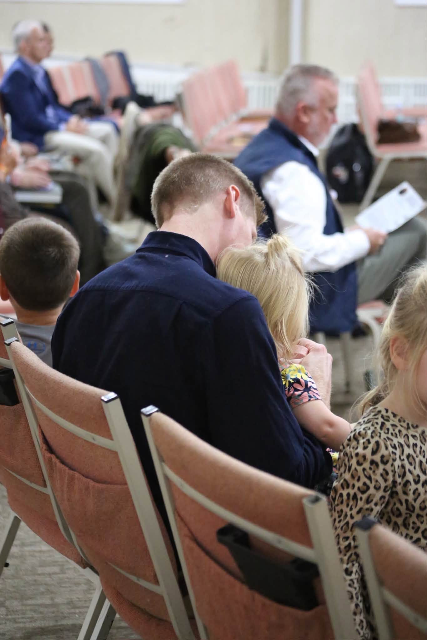 A father and daughter during the service