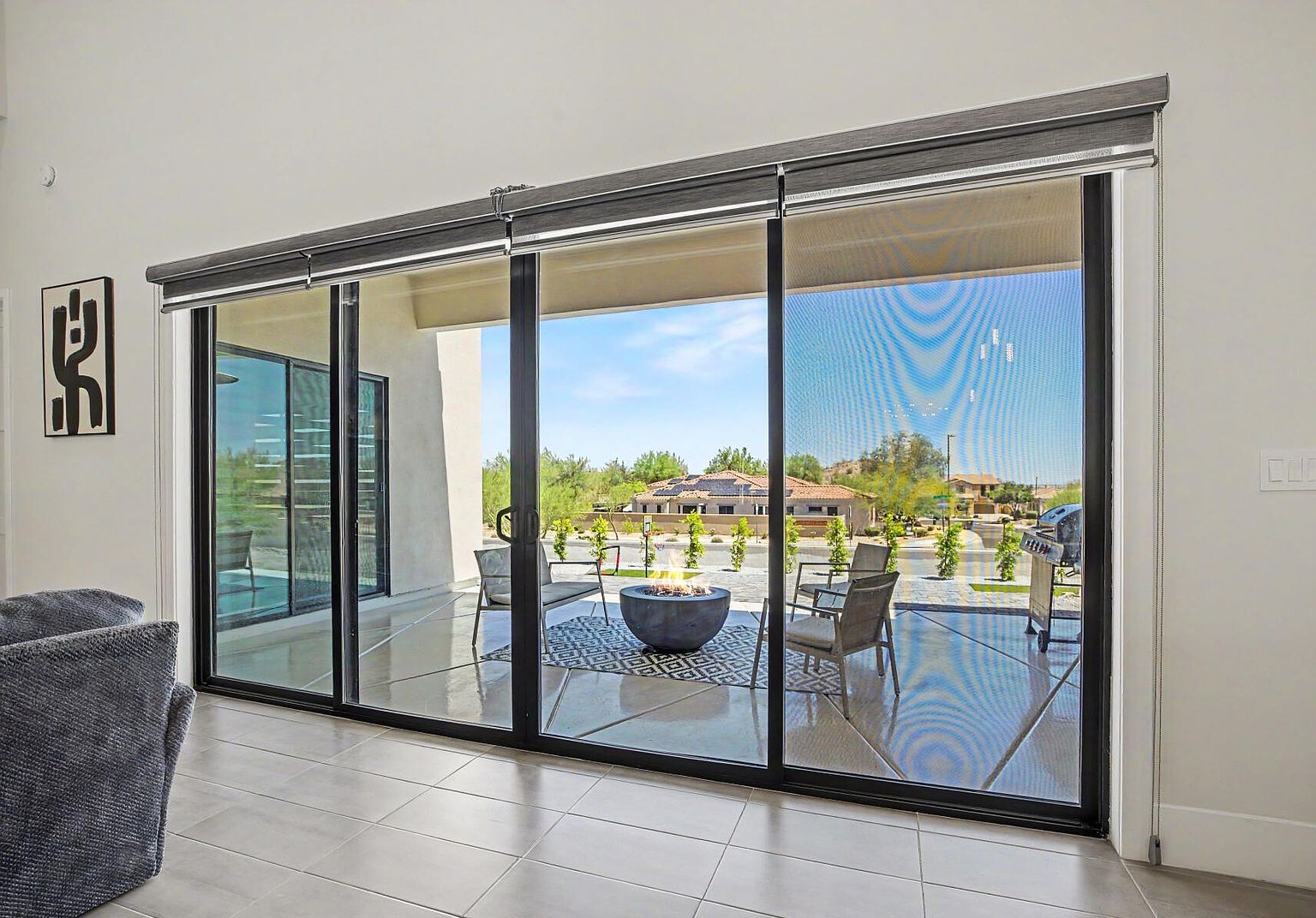 Indoor-outdoor living, sliding doors to covered patio with mountain view