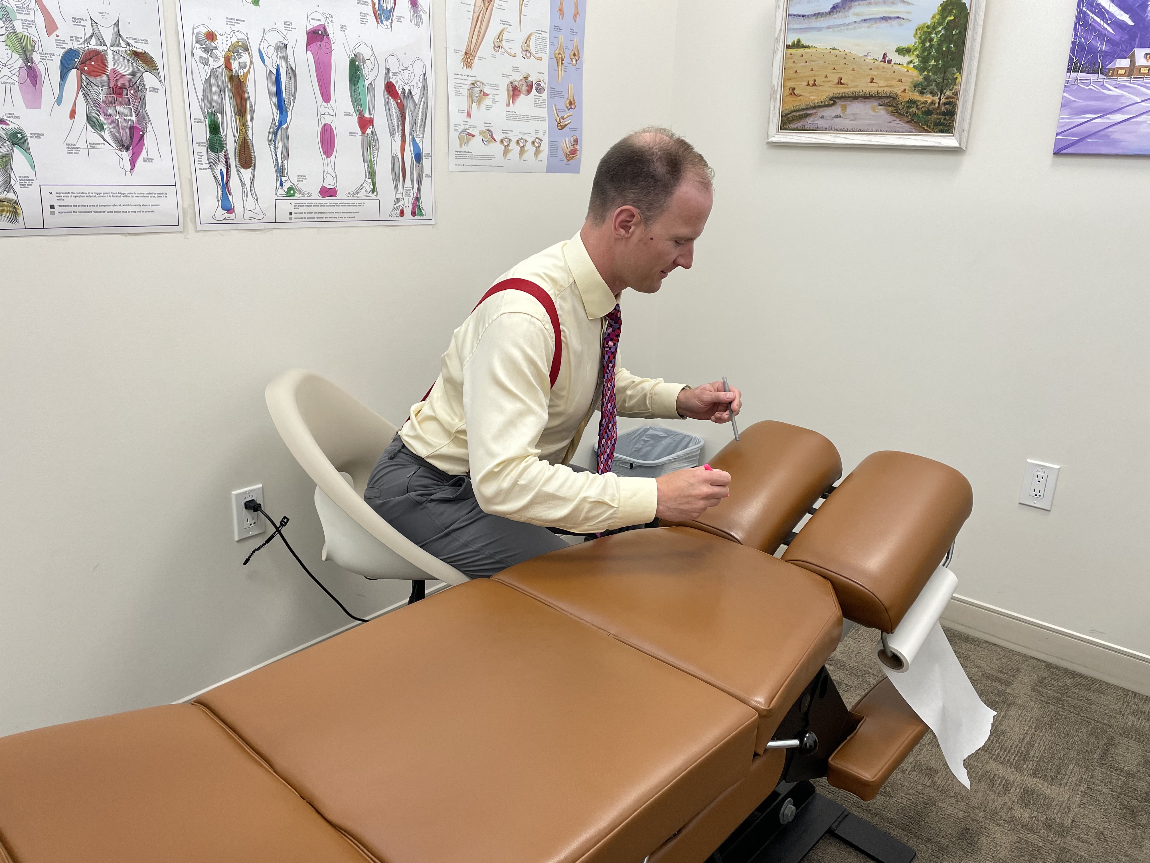 Chiropractor performing spinal adjustment on patient in Regina clinic