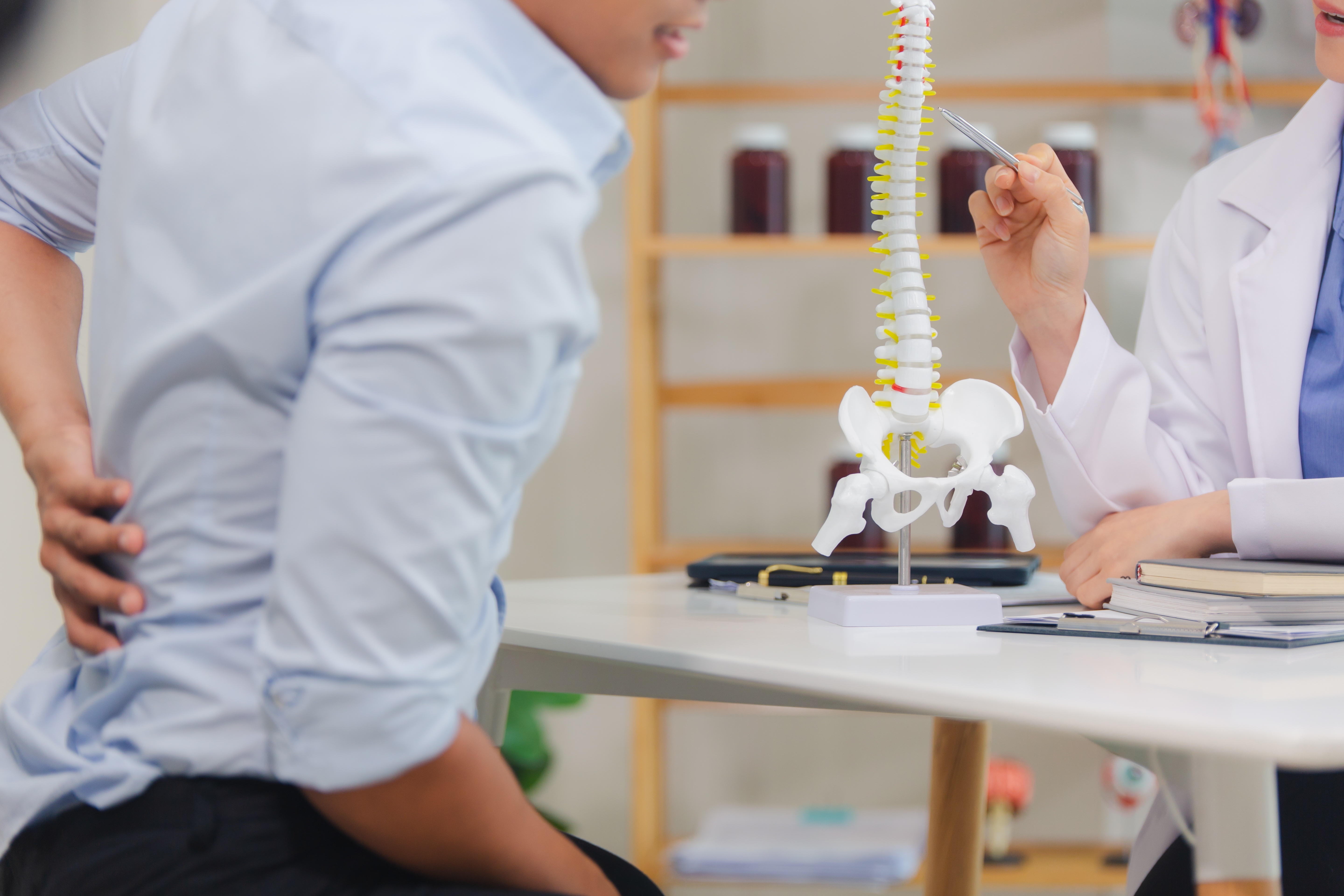 Chiropractor performing spinal adjustment on patient in Regina clinic