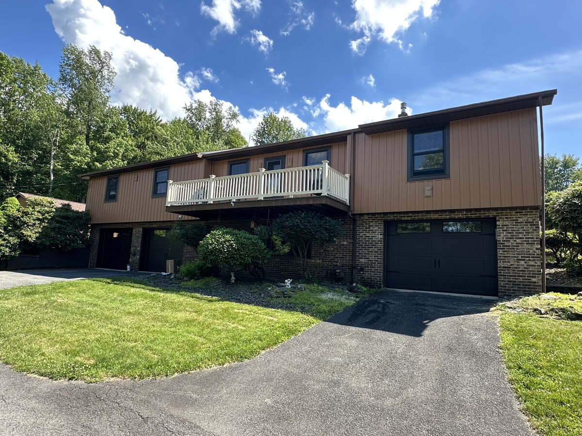 Large second-story deck addition on a home with metal roofing