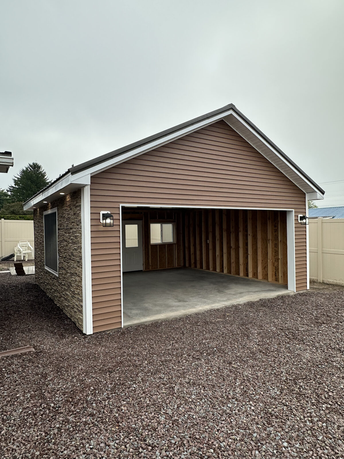 Detached two-car garage framed and sided, in progress