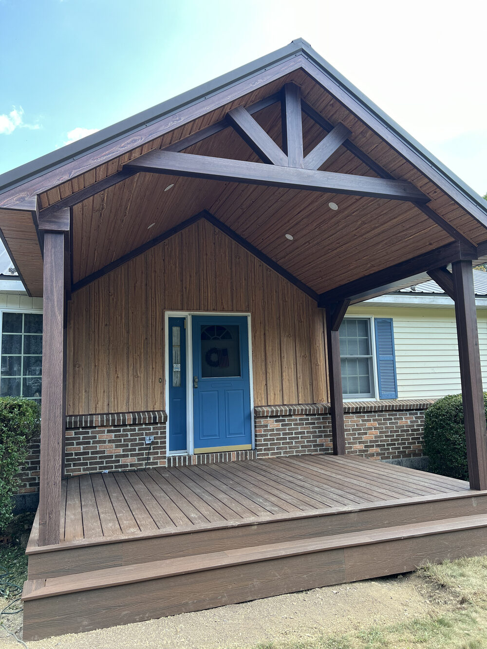 Covered front porch addition with matching metal roof