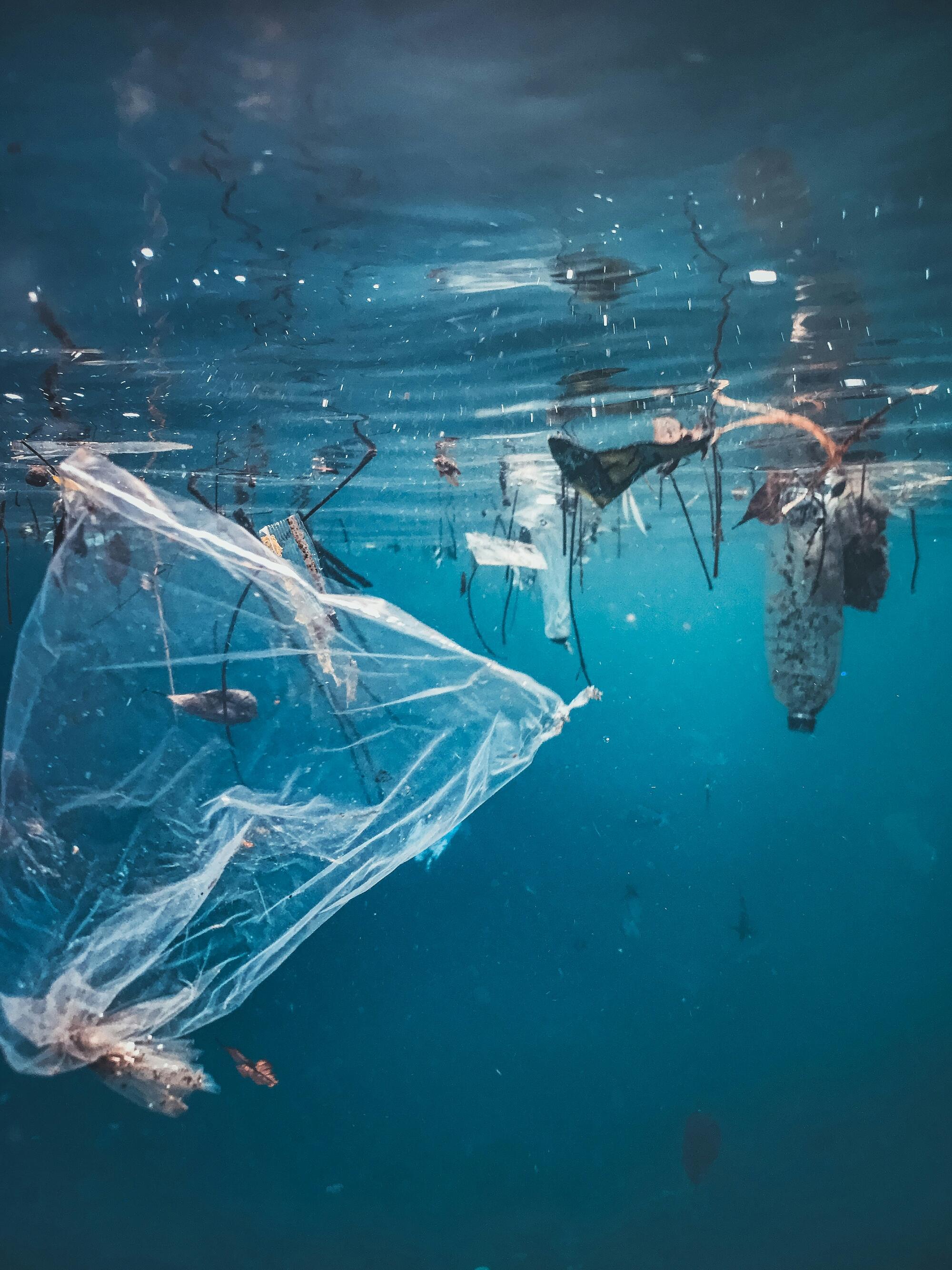Plastic debris and trash suspended underwater