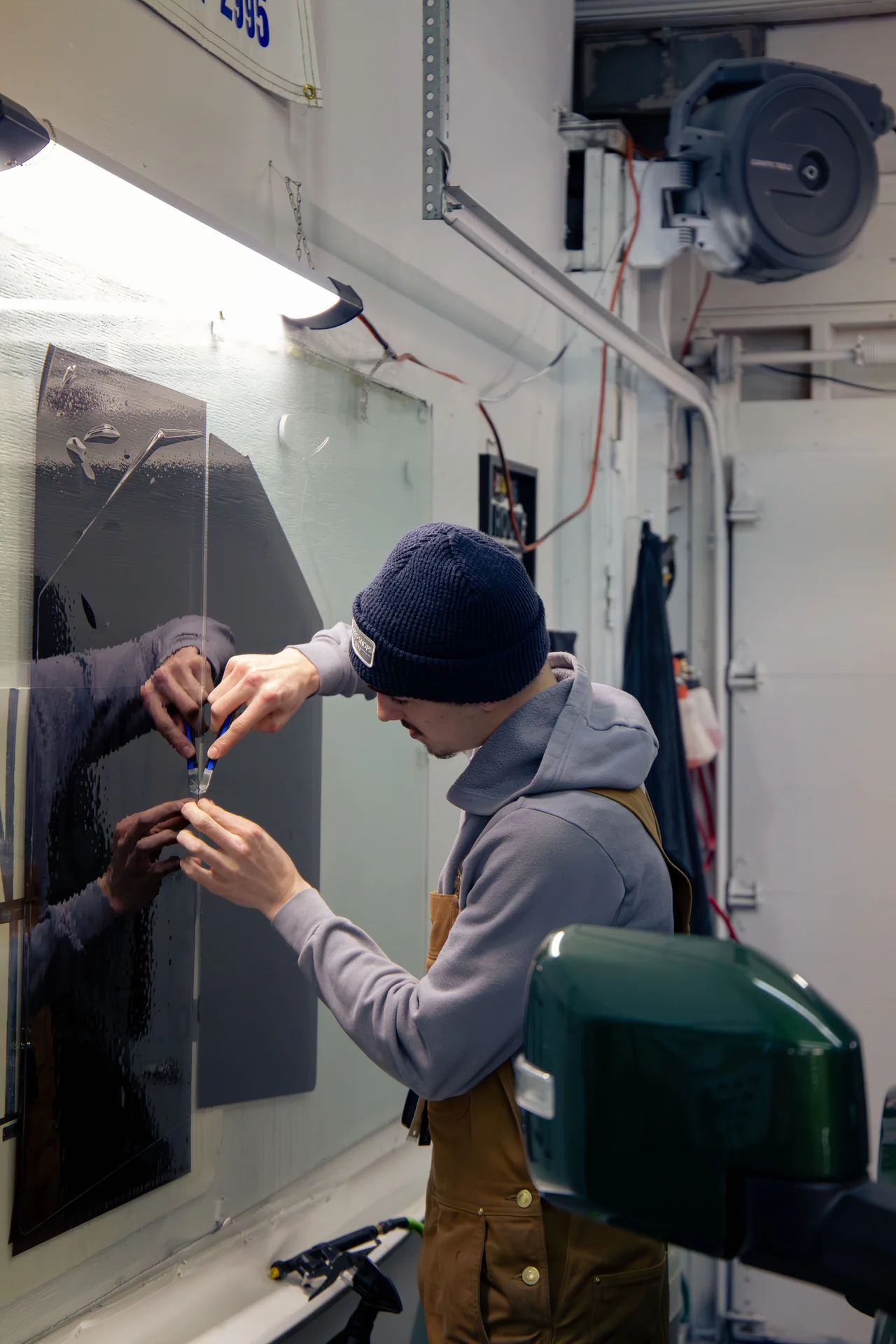 Trimming window tint film to size on a truck window