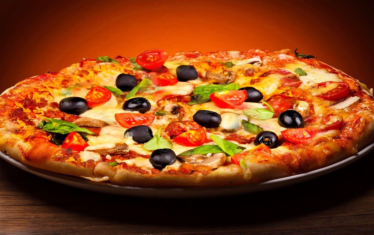 Hand holding a slice of pizza