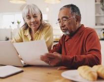 Senior couple reviewing their personalized plan at the kitchen table