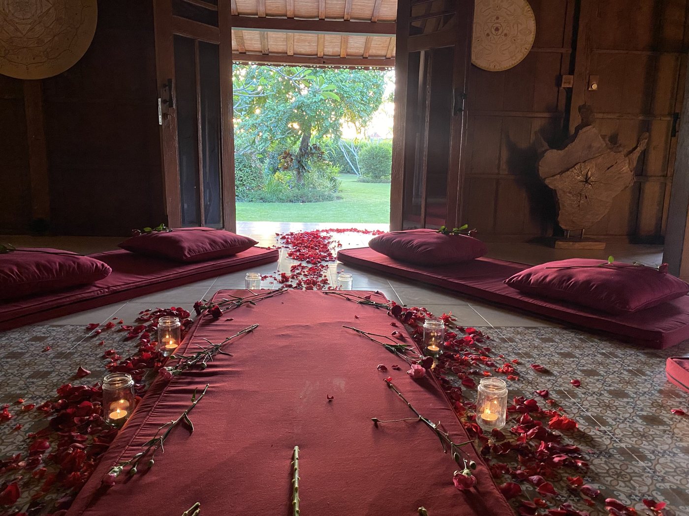 The joglo prepared for the ceremony, a long red cloth running down the centre, strewn with rose petals and lined with candles.