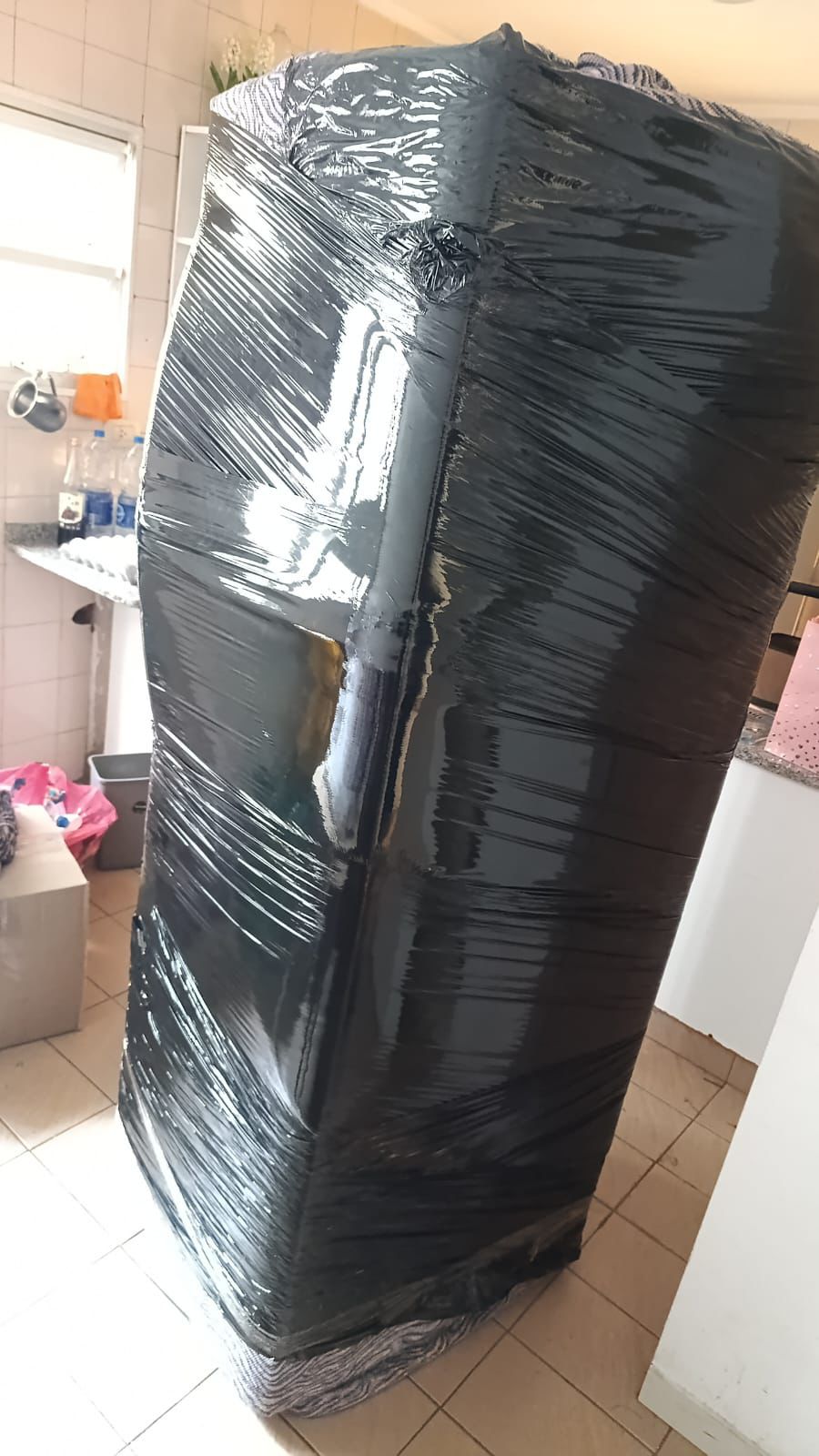 Mueble u objeto voluminoso envuelto en film dentro de una vivienda