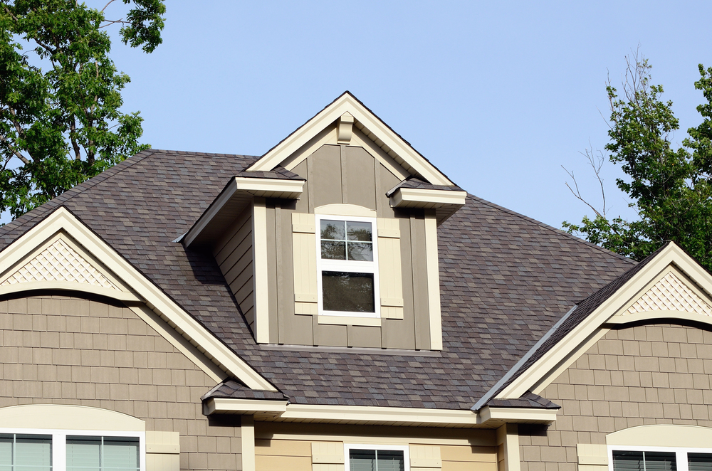 Roofing team inspecting a home exterior