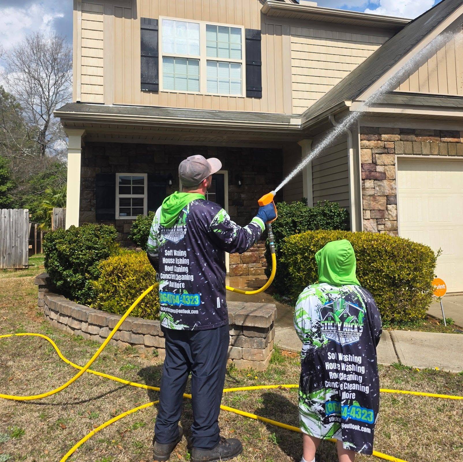 Sticky Rick's team washing the front of a house