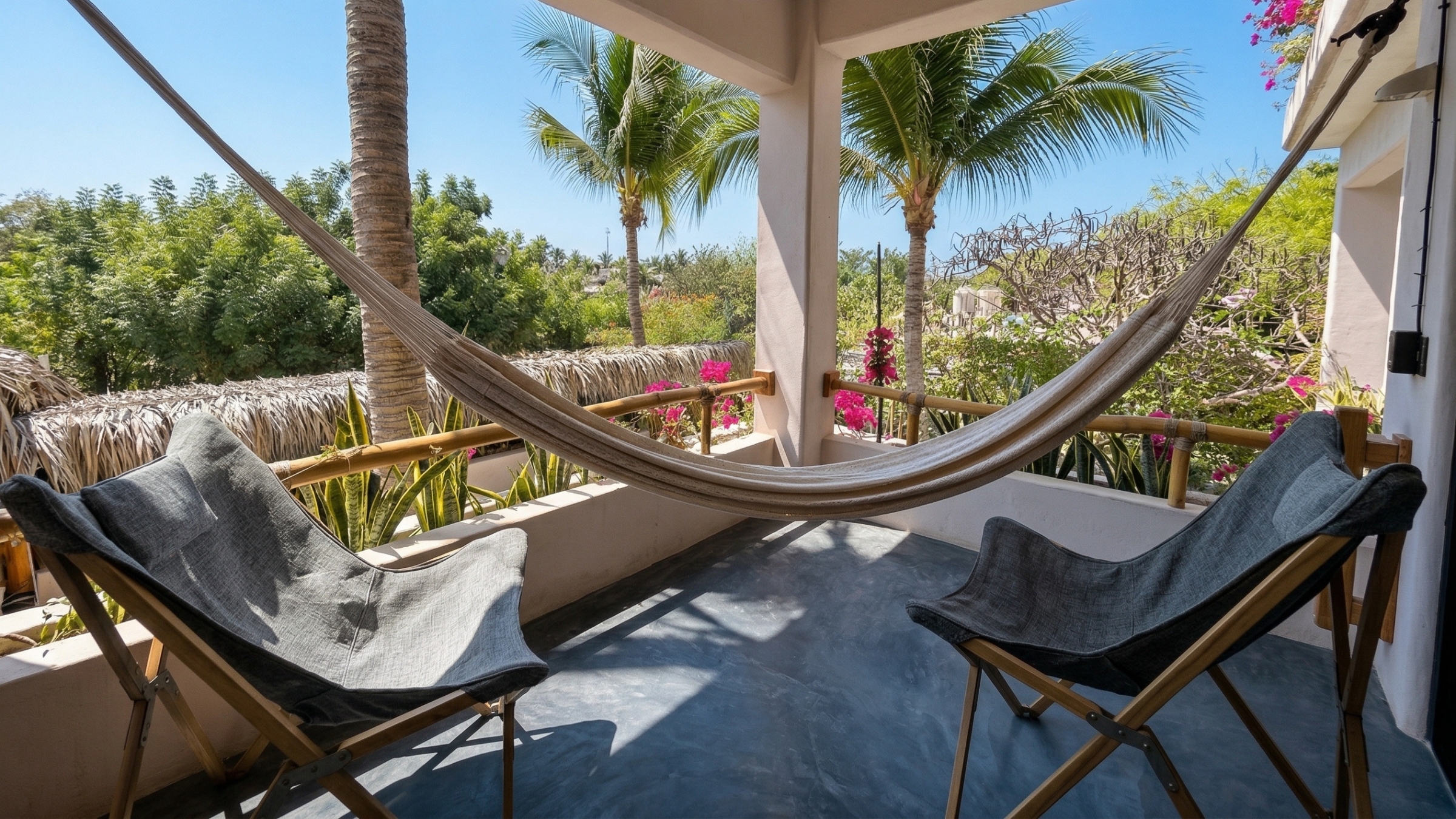 Private balcony with woven hammock and partial ocean view at the Balcony Suite — Casa Leah Puerto Escondido, Beach Boutique Hotel 47 steps from Zicatela