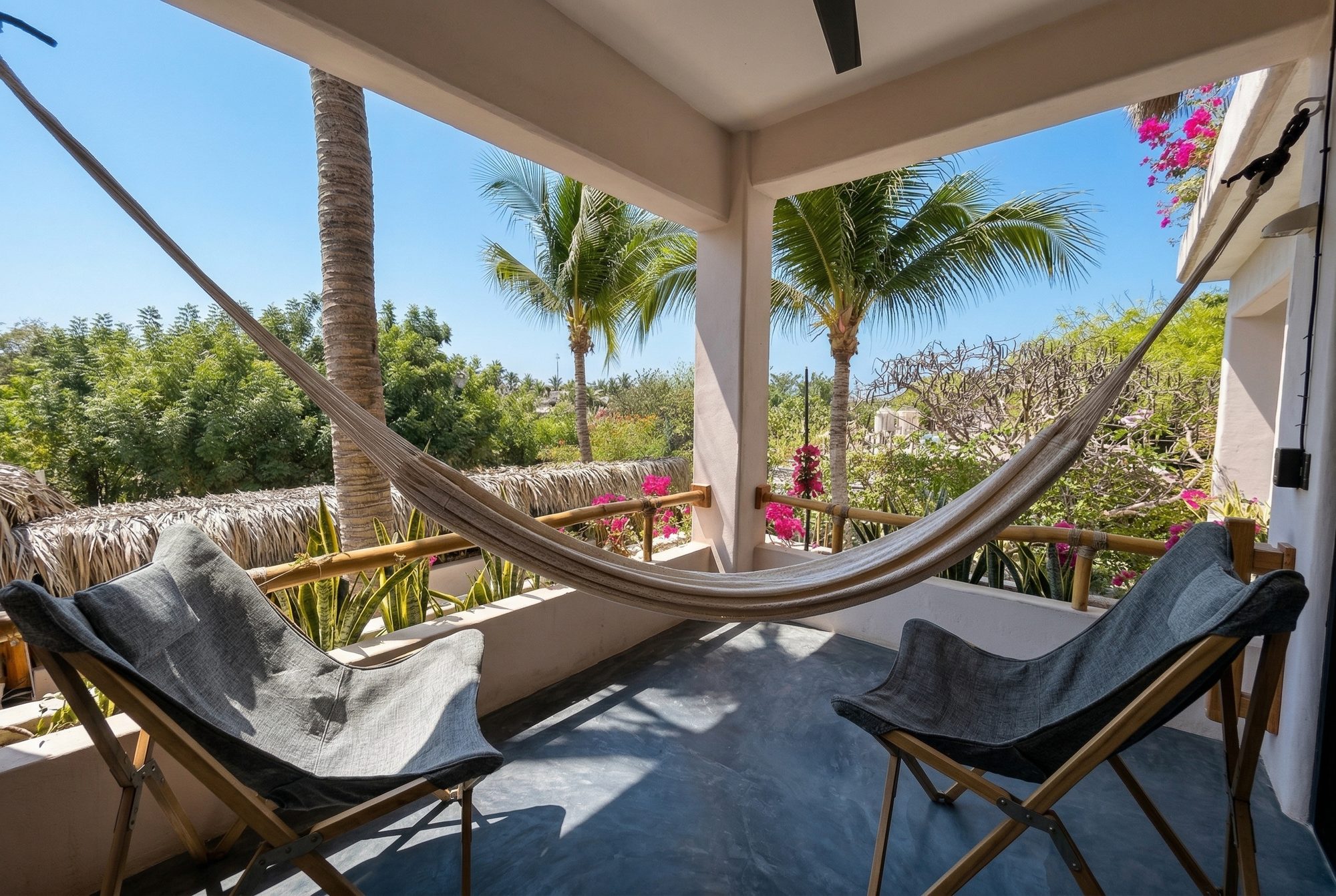 Private terrace hammock with ocean glimpse and tropical views