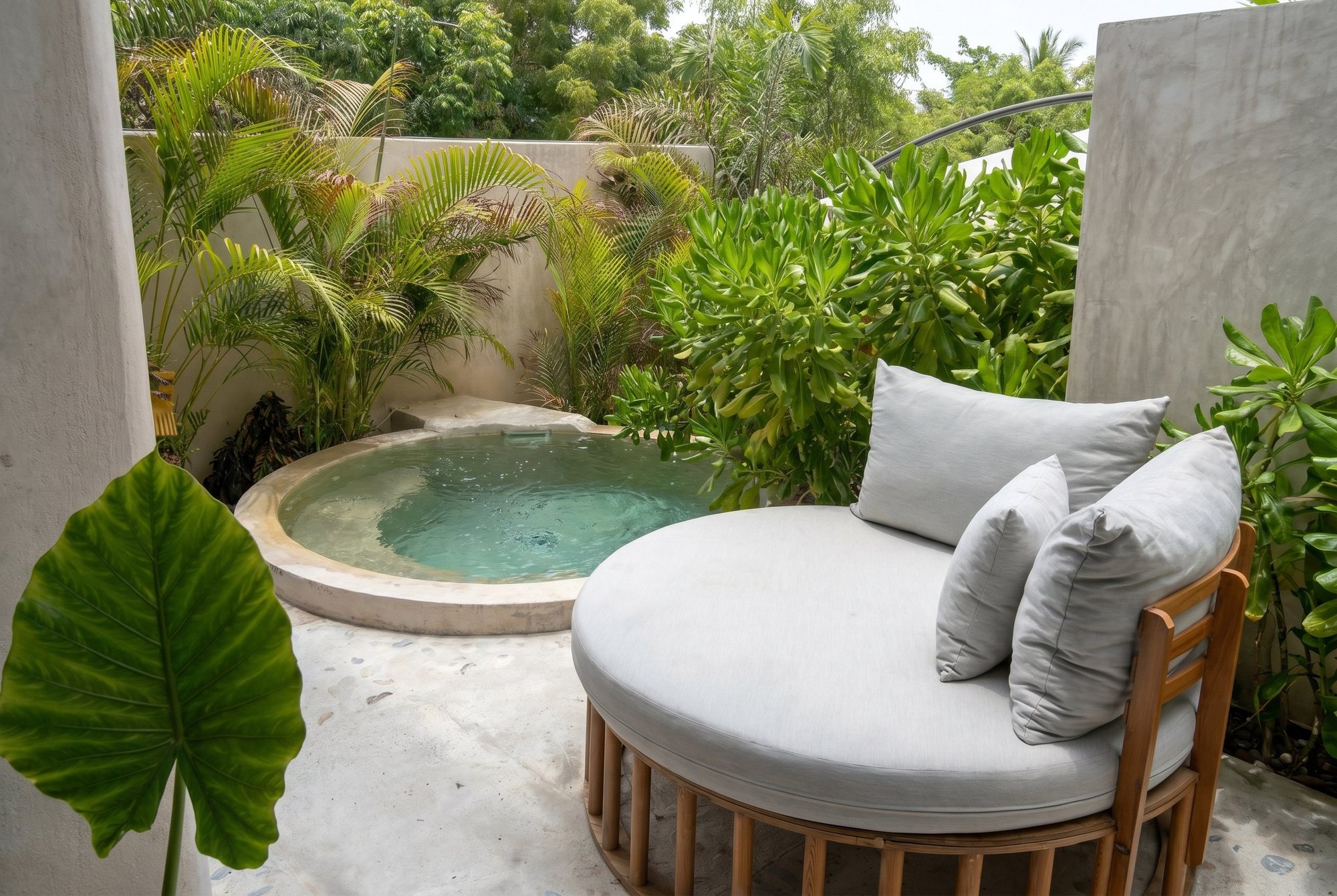 Private plunge pool with round daybed surrounded by tropical greenery at Casa Leah Plunge Pool Suite