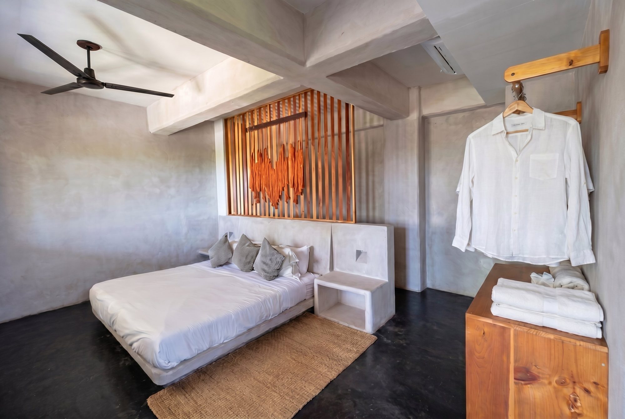 King bed loft bedroom with concrete nightstand and natural light at Casa Leah