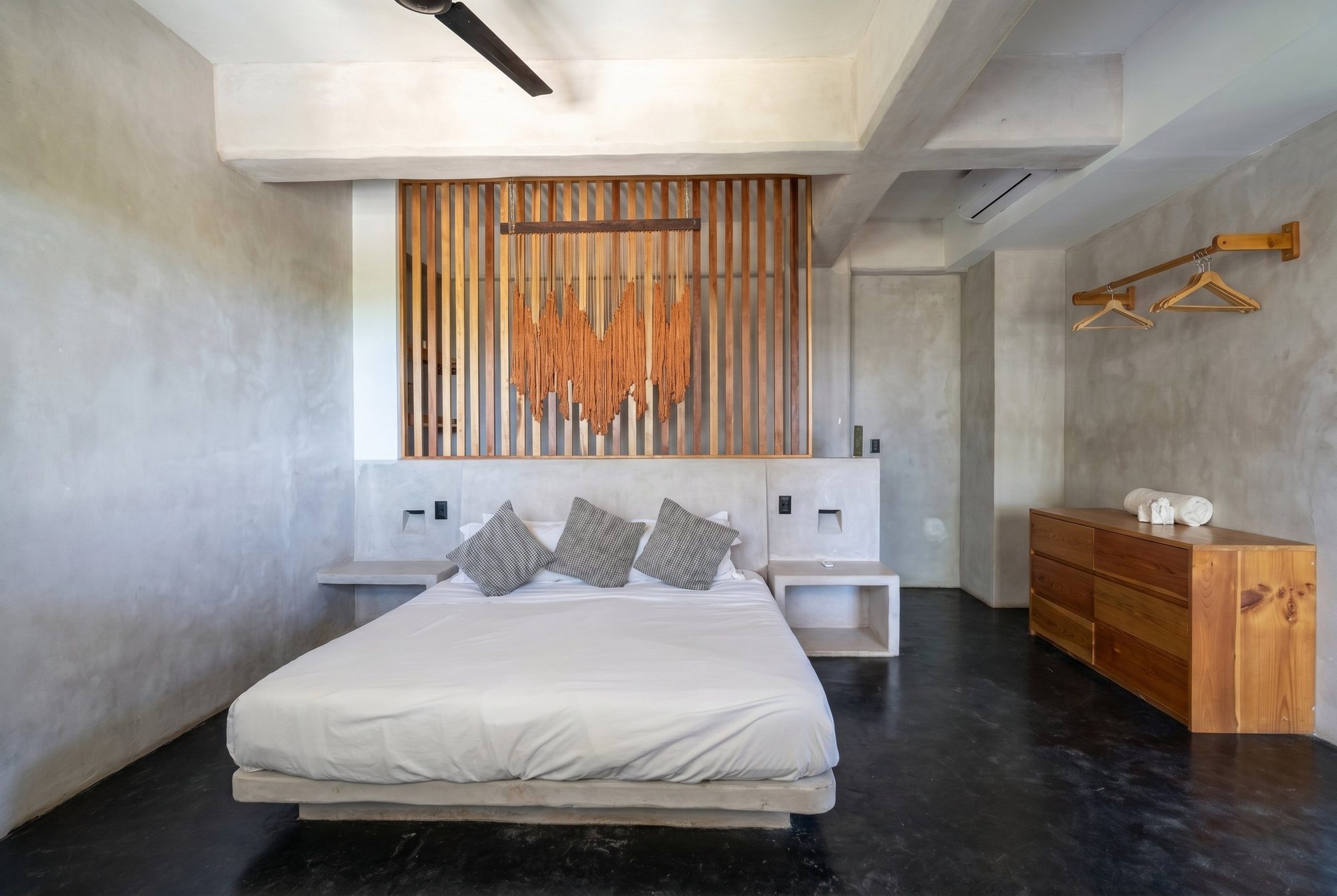Loft bedroom with king bed and wood macrame headboard at Casa Leah Plunge Pool Suite
