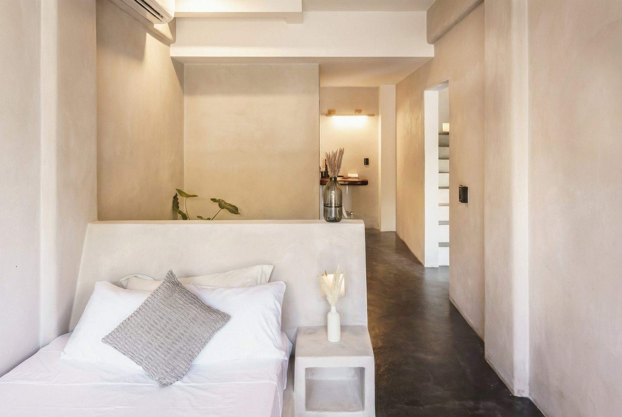 Second bedroom with a king bed and warm polished-plaster walls