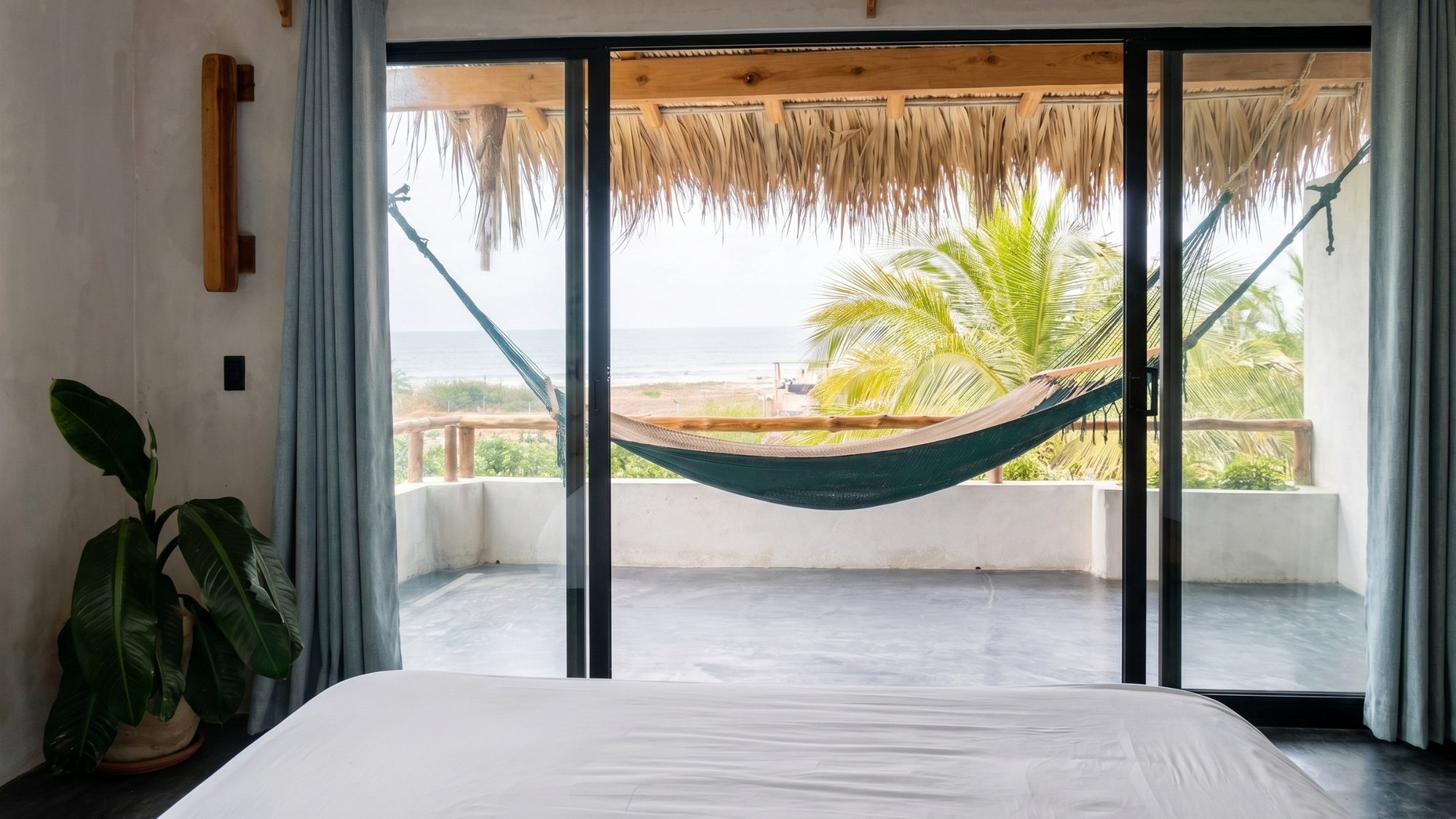 Master bedroom with ocean views, a woven hammock, and a private terrace