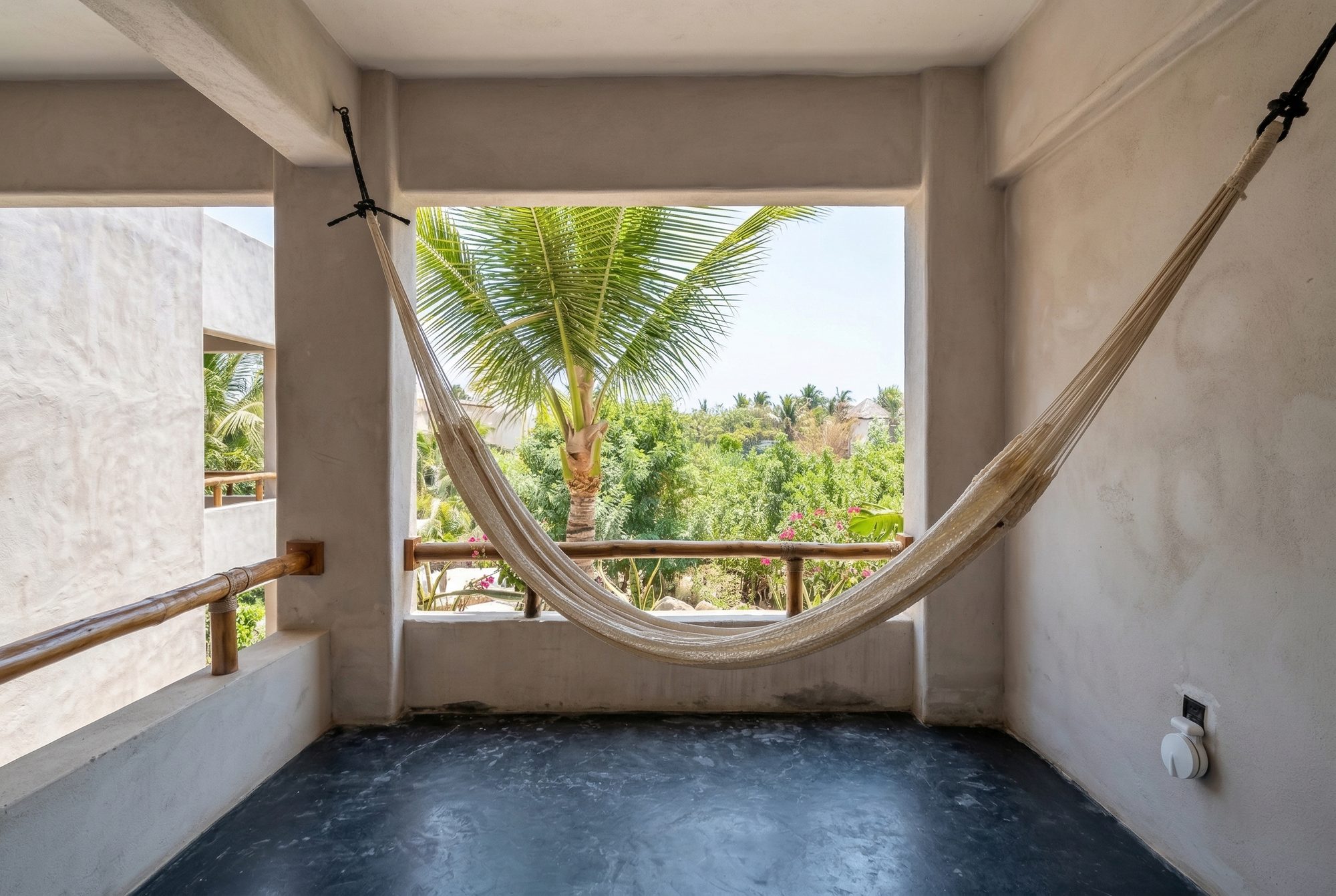Open living area with private balcony view to garden and tropical foliage at the Garden View Suite — Casa Leah Puerto Escondido, Beach Boutique Hotel 47 steps from Zicatela