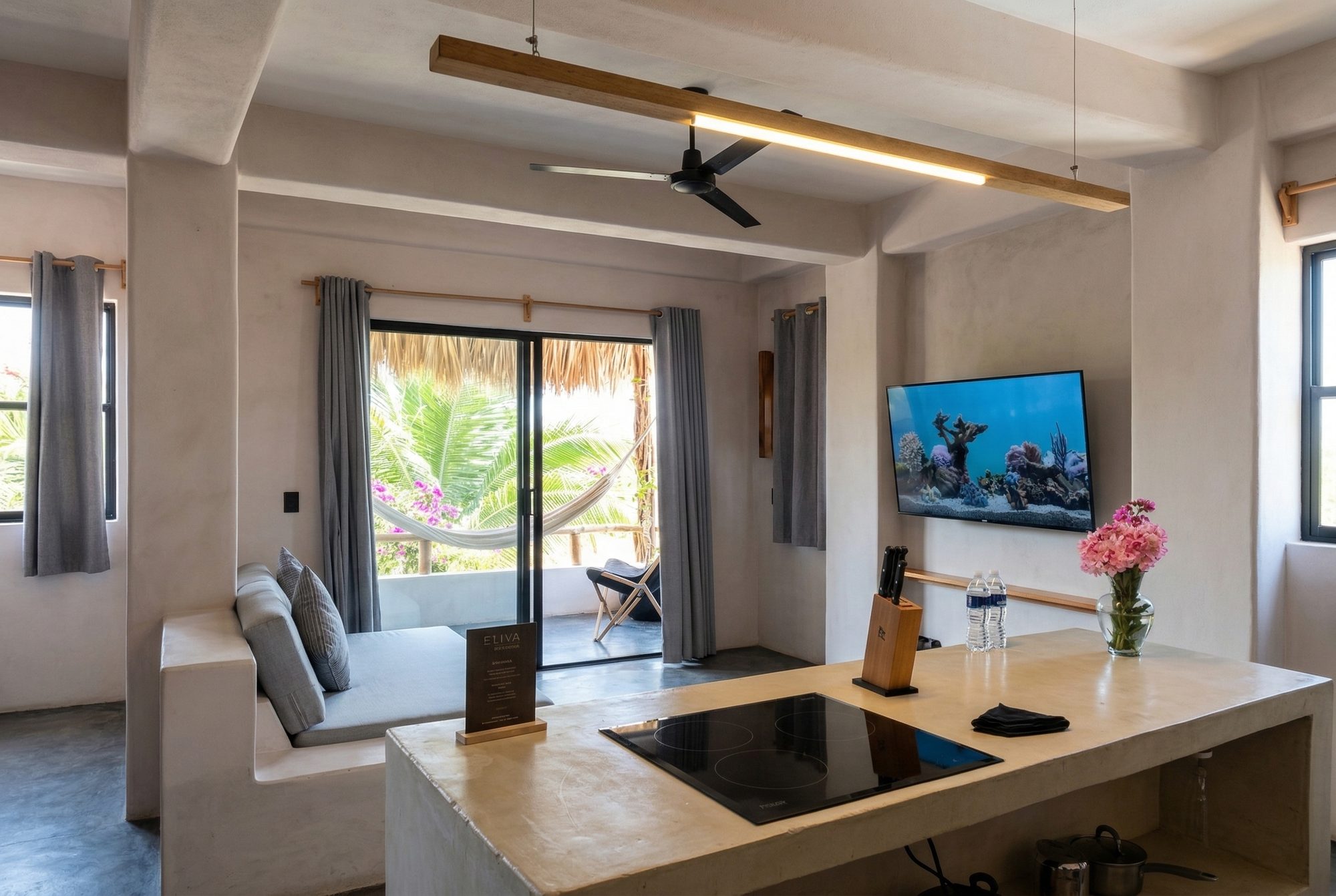Open-plan kitchen and living area with concrete island and private terrace