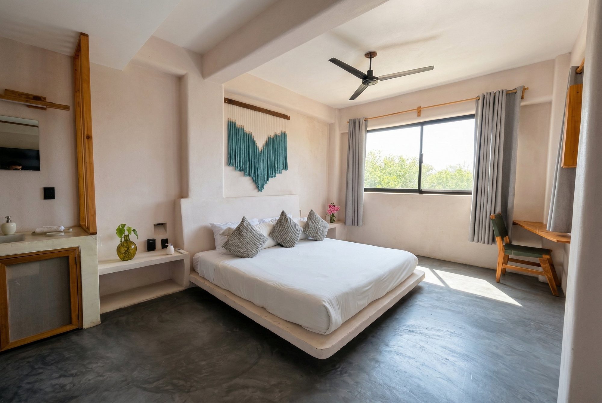Bedroom with a king bed, floating platform, and garden-view window