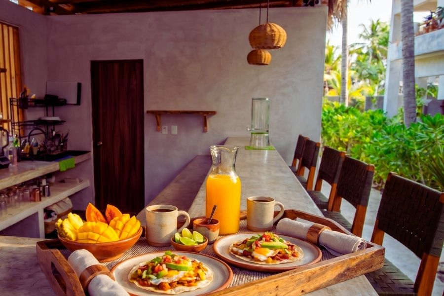 Fresh Mexican breakfast with chilaquiles, tropical fruit and juice at Casa Leah Puerto Escondido