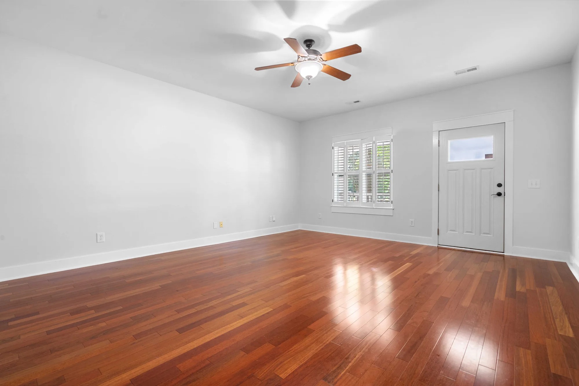 Virtual staging of a staged dining and living area with warm wood accents
