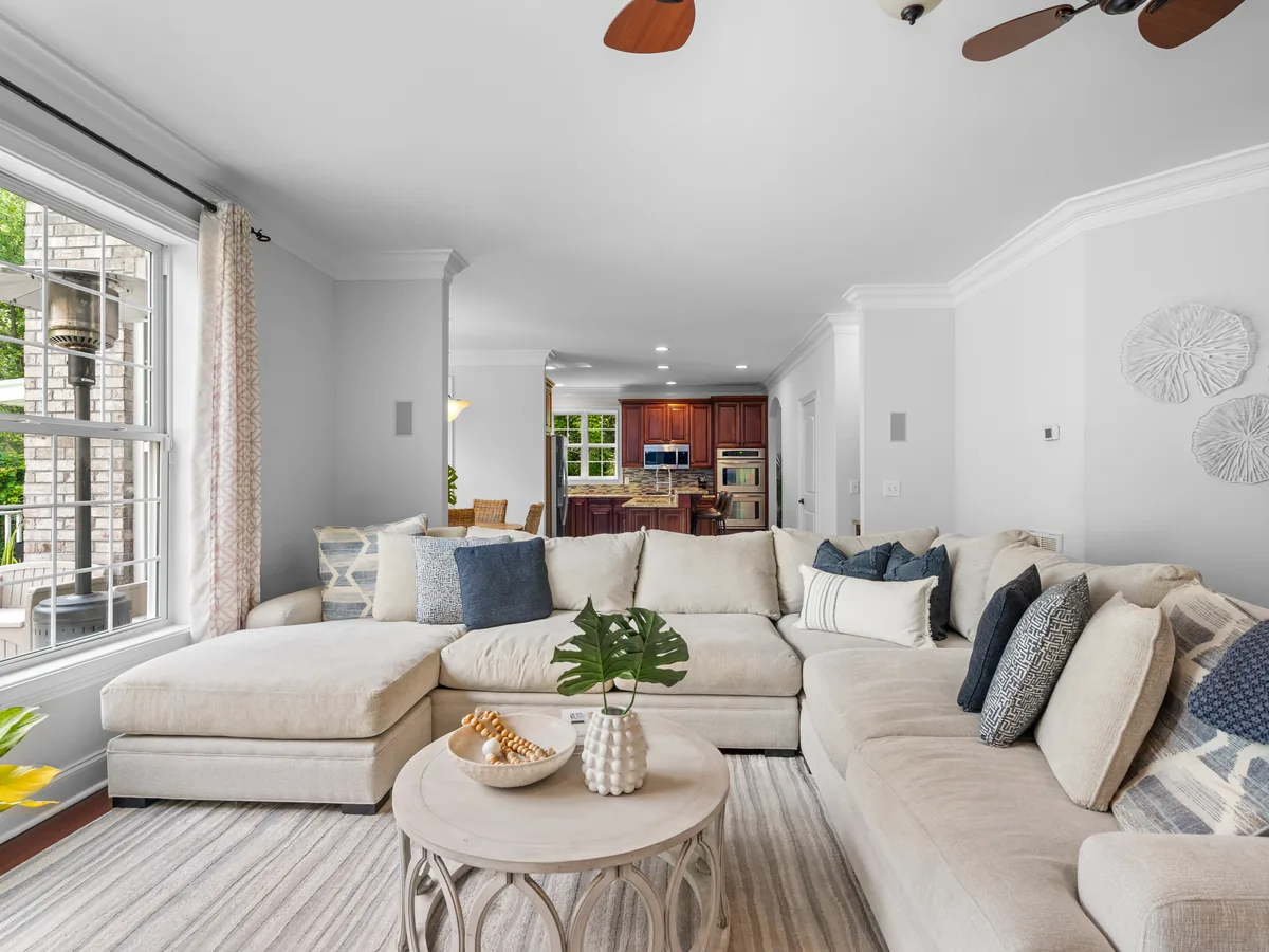 Living room with a large sectional sofa and a kitchen in the background