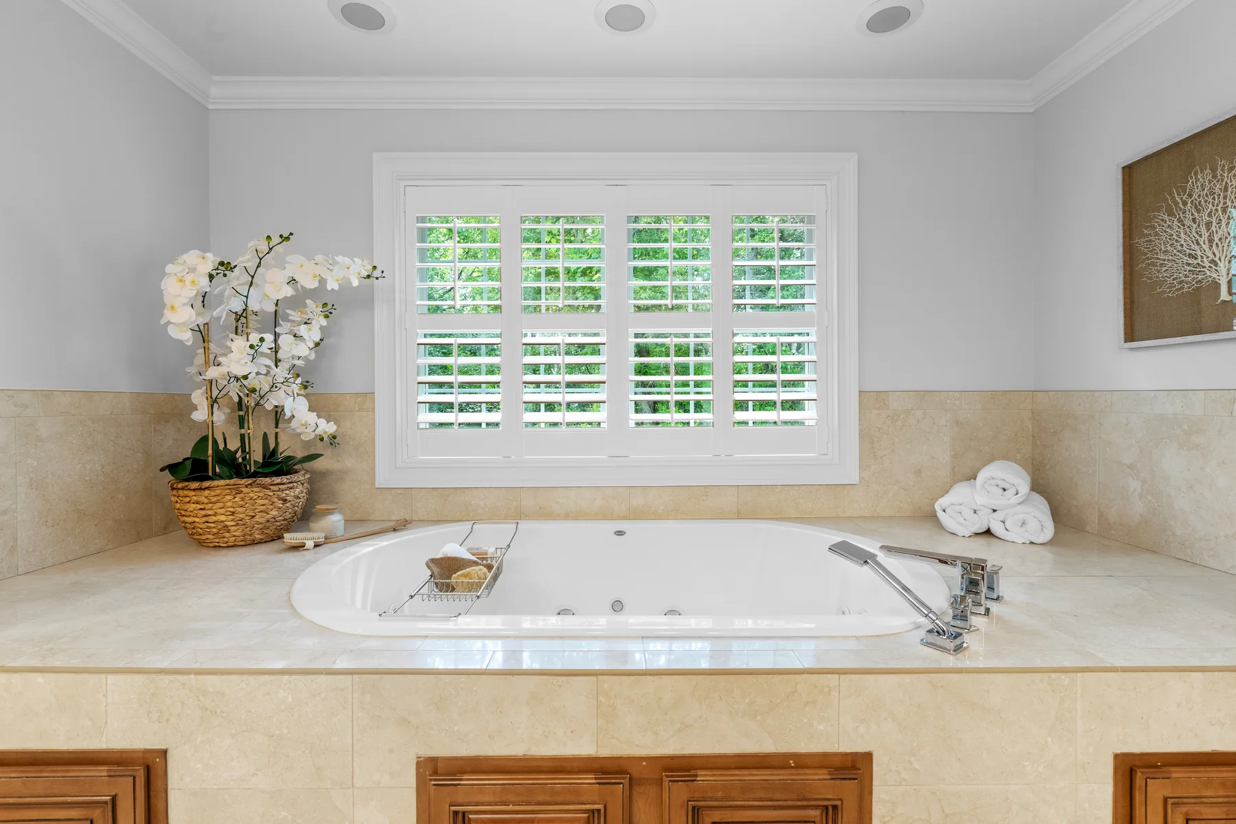 Bathroom with a large window, a bathtub, and a potted plant