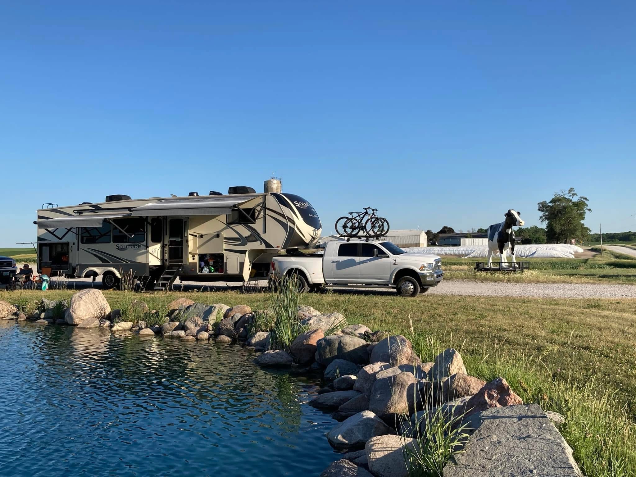 RV parked beside a peaceful pond