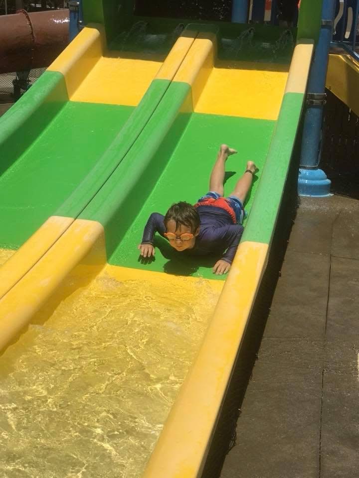 Kid on a water slide having fun