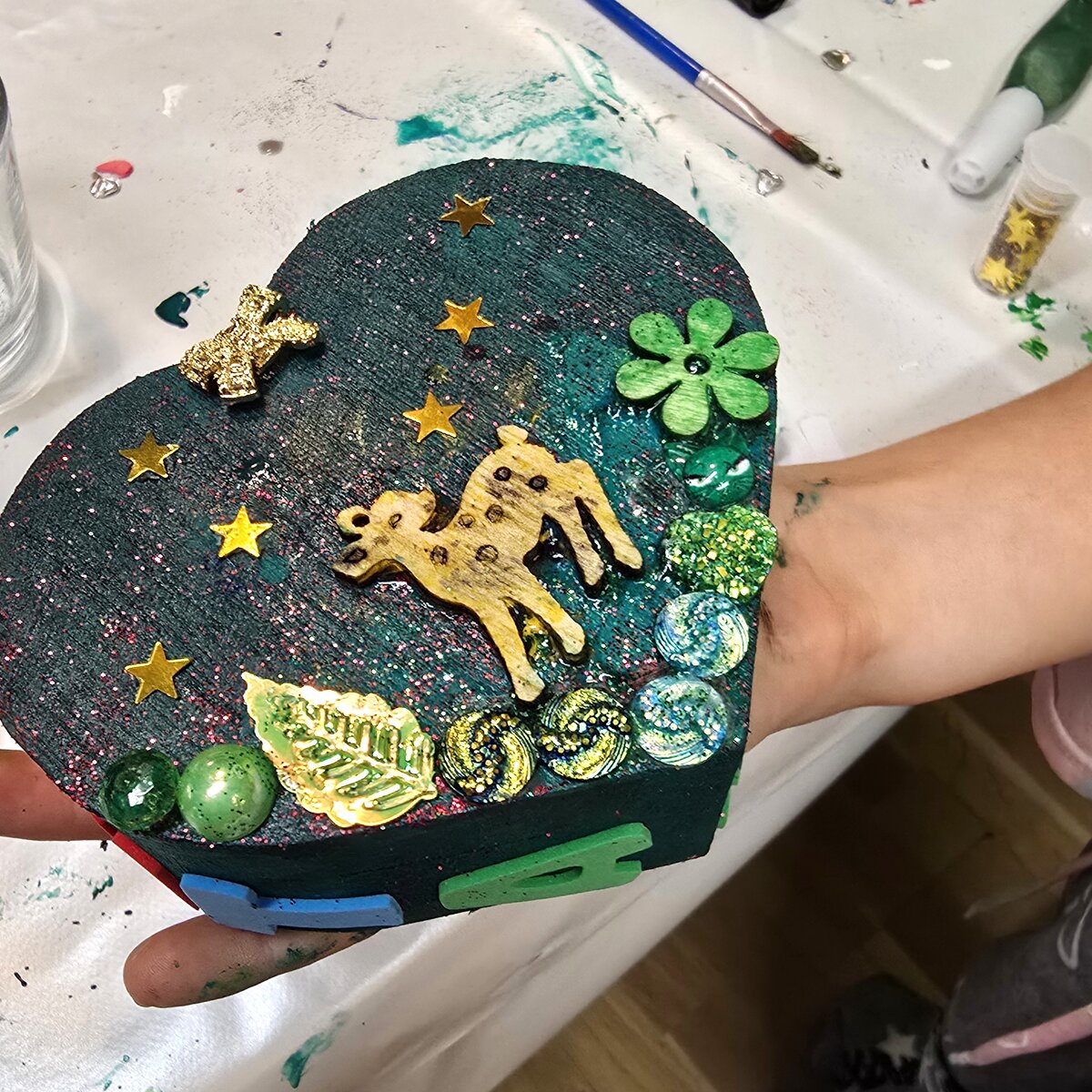 Hands holding a hand-decorated heart